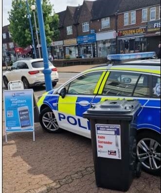 A Police car and a knife amnesty bin.