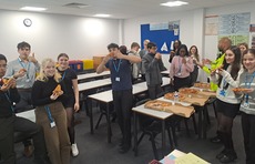 Students having a slice of pizza after a visit from Police. 