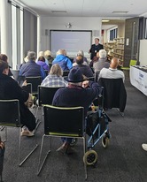 Speaker and audience at cyber crime and fraud prevention event