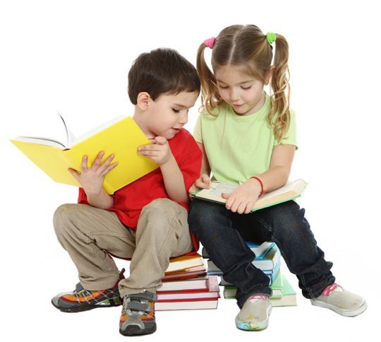 Two children sat on a pile of books, reading a book