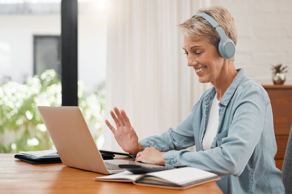 A lady on a Zoom meeting on her laptop