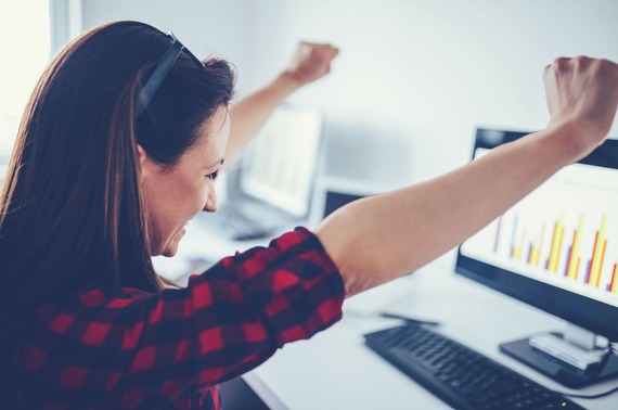 a lady celebrating at her computer