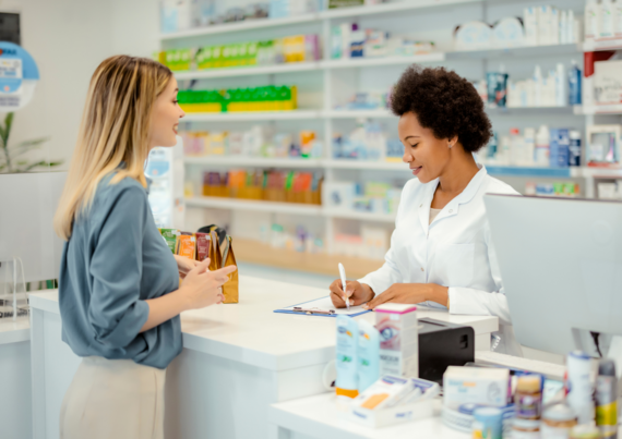 a woman talking to a pharmacist