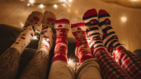 fluffy Christmas socks in front of some fairy lights