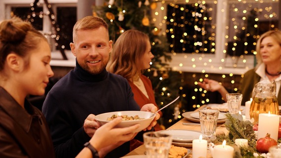 a group of people having a Christmas dinner together