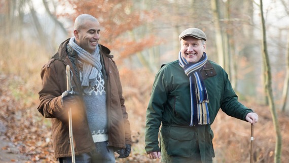 two men walking in the woods together