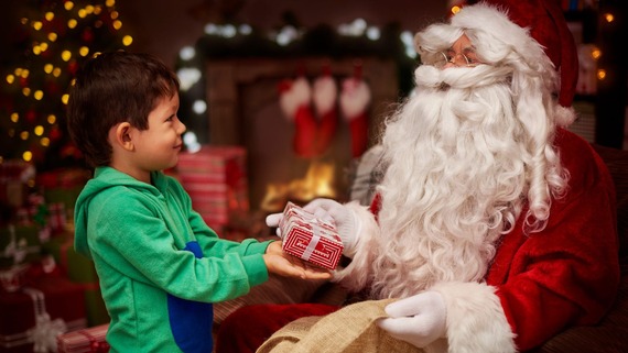 father christmas handing a gift to a child