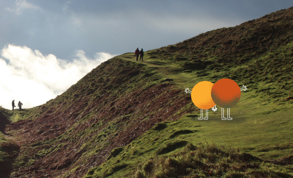 two talk community 'hector' mascots stood on the malvern hills