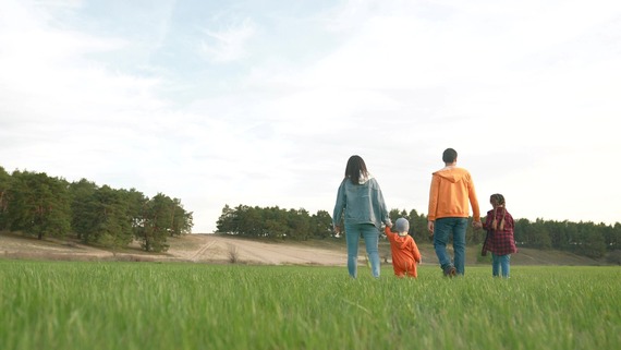 a family walking through a field together
