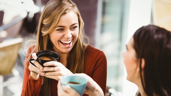 two friends drinking coffee and chatting