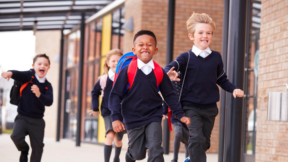 primary school children running in their uniform
