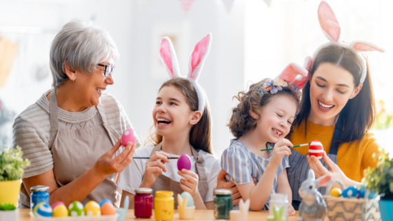 a family painting easter eggs