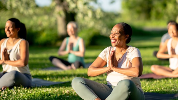 a group of people doing park yoga