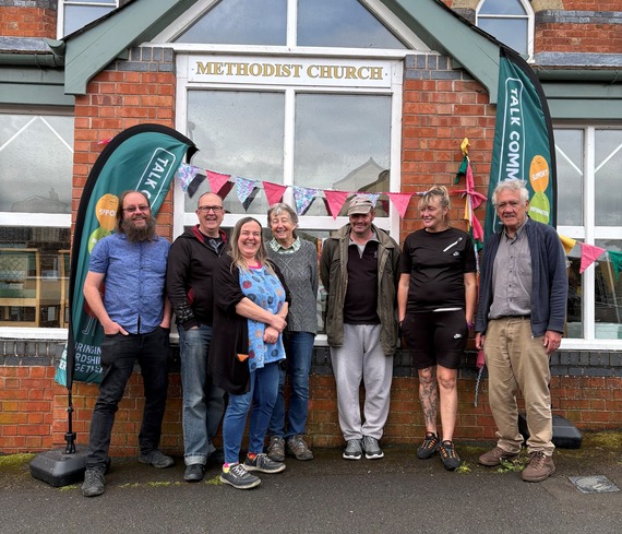 volunteer team smiling in front of the Methodist church