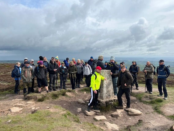 a group walkers on top of the malvern hill