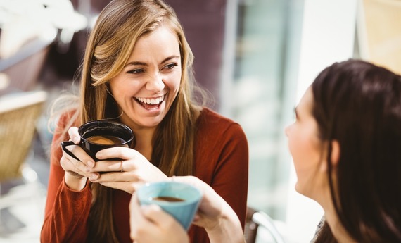 a woman drinking a cup of tea