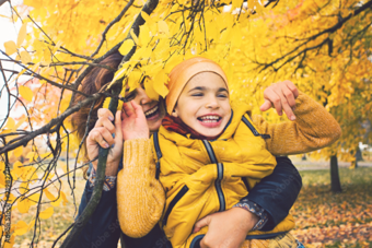 Child in autumn leaves
