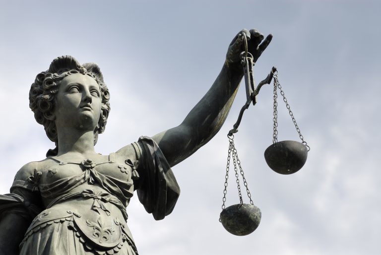 Statue of justice figure holding scales