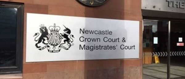 An image of the outside of Newcastle Magistrates' Court and the building sign