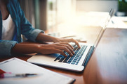 Woman typing at laptop