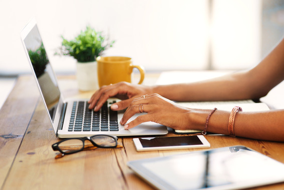 Person working from home typing on a laptop