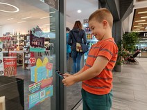 Child scanning QR code sticker