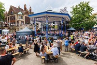 The Carfax bandstand surrounded by people enjoying the Jubilee entertainment