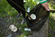 Litter-picking in a black rubbish bag