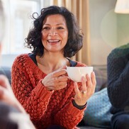 Woman with curly hair drinking tea 