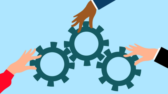 Cogs with hands moving the wheels