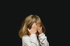 Image of Child covering face
