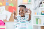 Image of child with thumbs up