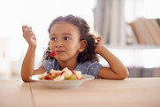 Image of child eating fruit