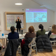 Classroom with pupils whose hands are raised
