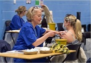 A healthcare worker gives a meningitis vaccination to a student at a mass vaccination clinic at Canterbury University