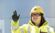 Female worker on site wearing hard hat and high vis