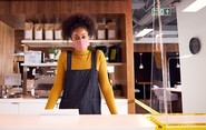 young woman wearing mask in coffee shop