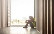 male construction worker sat on floor