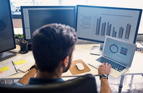 male worker with multiple screens