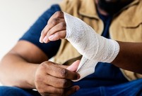 a sprained wrist being treated with first aid