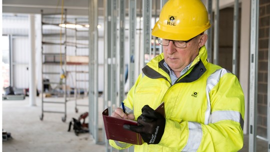 HSE inspector writing in notebook