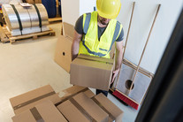 site worker lifting a box