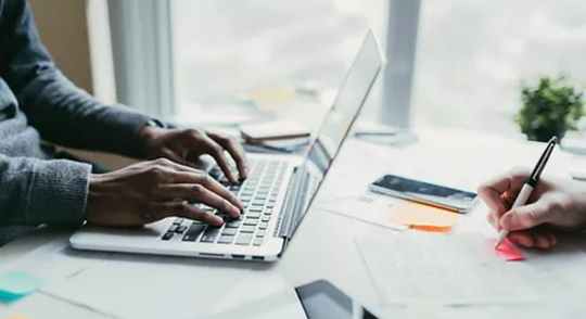 Person typing on laptop