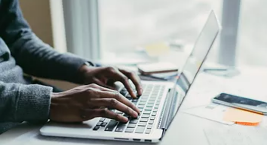 Person typing on laptop