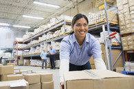 female worker lifting boxes in warehouse