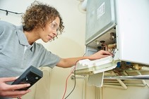 female electrical worker checking appliance