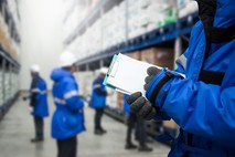 hand of worker with clipboard checking goods in warehouse