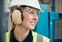 young female apprentice on site wearing PPE