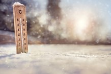 thermometer stuck in snowy field