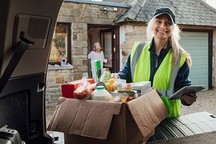 volunteer helping with food delivery